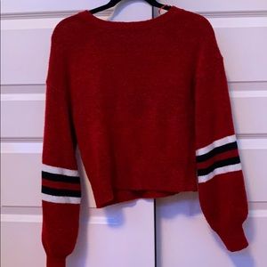 red sweater with striped sleeves